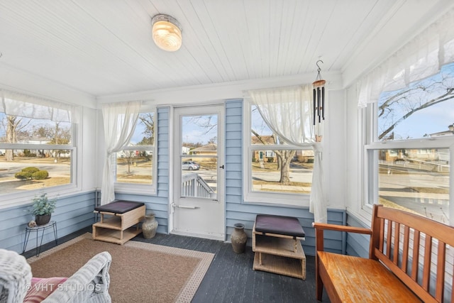 sunroom / solarium with plenty of natural light and wooden ceiling