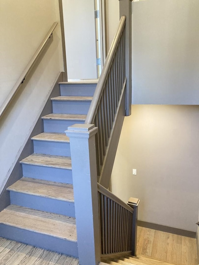 staircase with wood finished floors