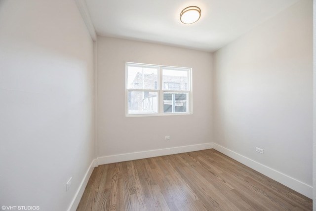 empty room with light wood-style floors and baseboards