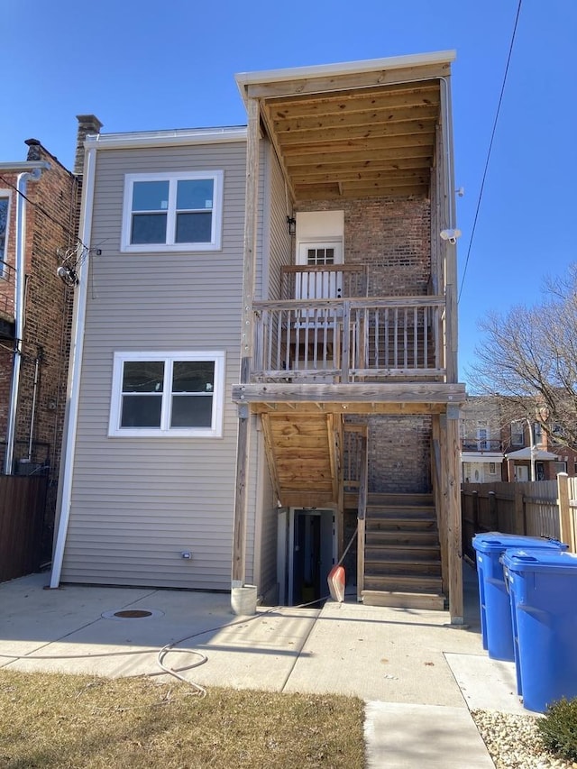 back of property featuring stairs, a patio area, and fence