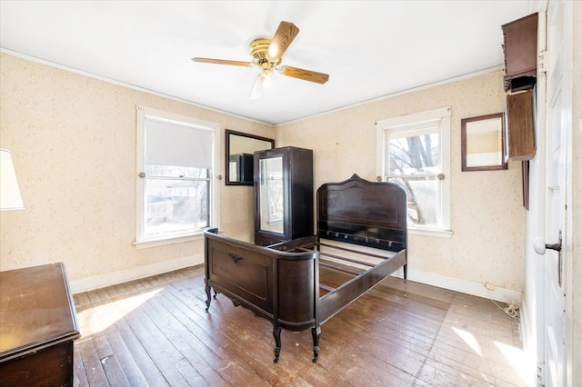 bedroom with baseboards, hardwood / wood-style floors, and wallpapered walls