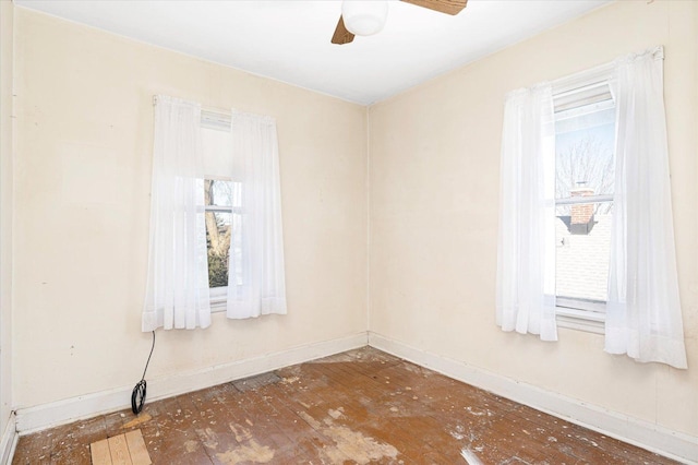 unfurnished room featuring baseboards and a ceiling fan