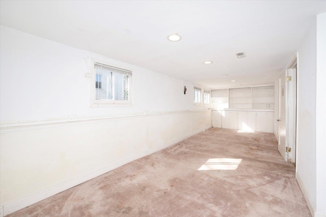 hallway with carpet floors, visible vents, baseboards, and recessed lighting