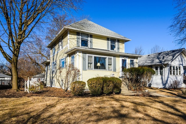 traditional style home with fence and a front lawn