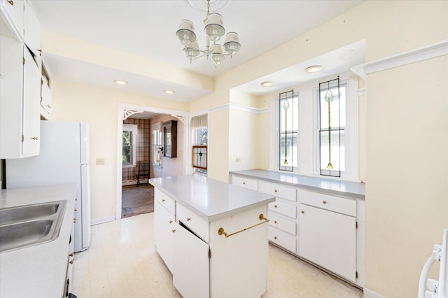 kitchen featuring light countertops, a kitchen island, white cabinetry, and recessed lighting