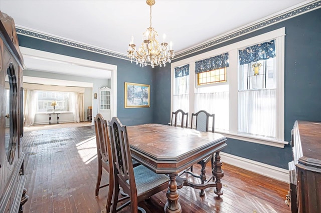 dining room featuring hardwood / wood-style floors, a wealth of natural light, and baseboards