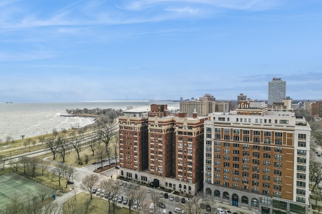 birds eye view of property featuring a water view and a view of city