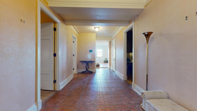 corridor with baseboards, crown molding, and dark tile patterned flooring