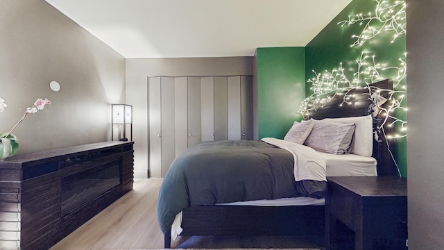 bedroom featuring a closet and wood finished floors