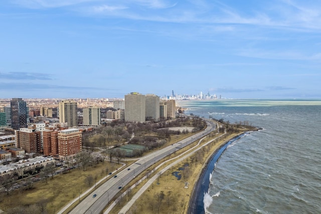 birds eye view of property featuring a view of city and a water view