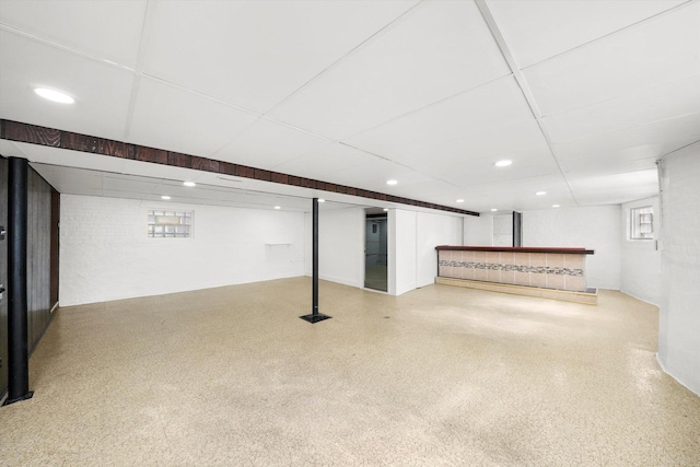 below grade area featuring a paneled ceiling and recessed lighting