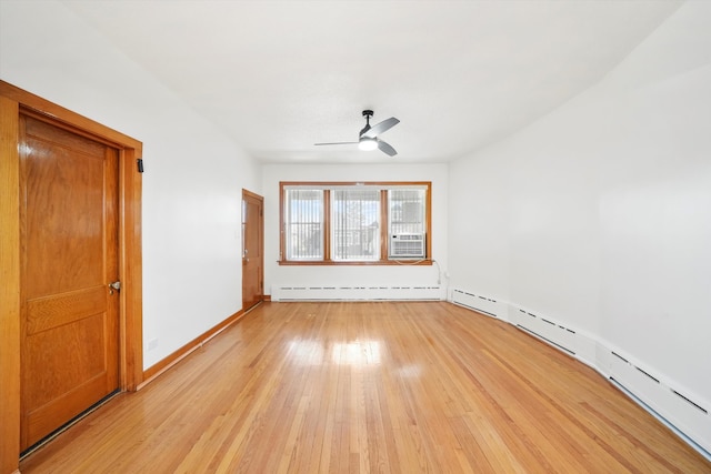 empty room with light wood-type flooring, ceiling fan, a baseboard heating unit, and cooling unit