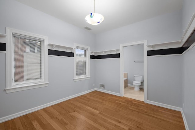 walk in closet featuring visible vents and wood finished floors