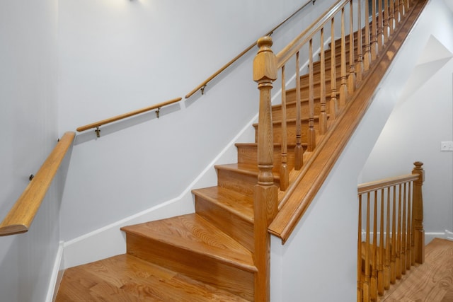 stairs featuring wood finished floors