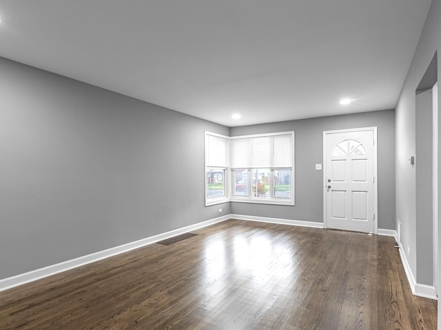 interior space with recessed lighting, dark wood-style flooring, visible vents, and baseboards