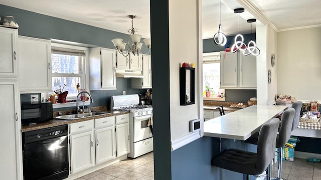 kitchen featuring under cabinet range hood, a peninsula, a sink, white cabinetry, and black appliances