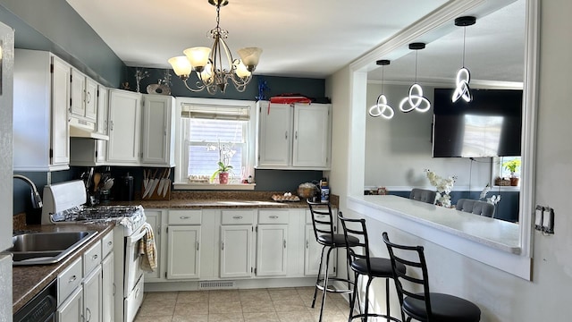 kitchen featuring visible vents, dishwasher, hanging light fixtures, white gas stove, and under cabinet range hood