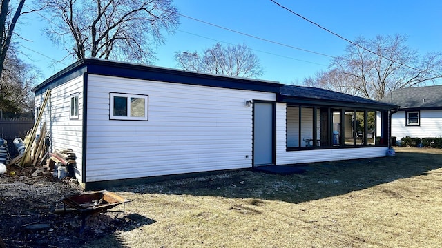 rear view of property featuring a sunroom