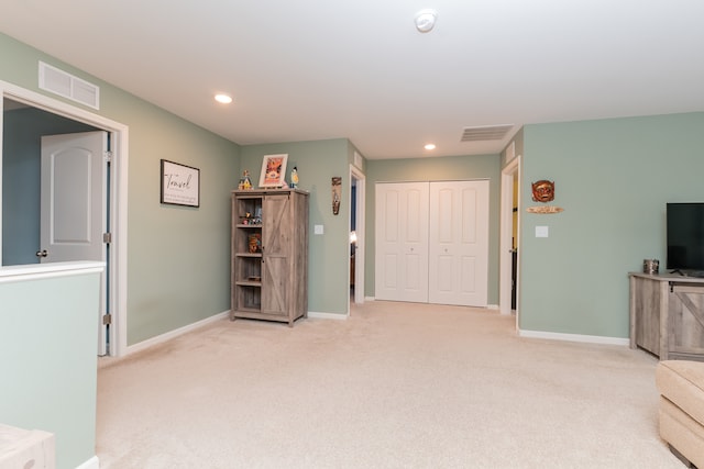 unfurnished room featuring light colored carpet, visible vents, and recessed lighting