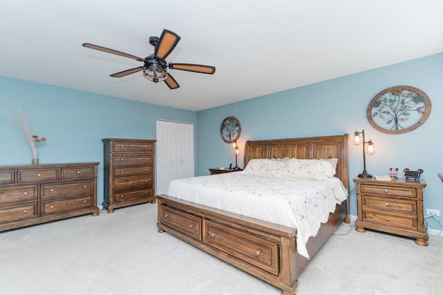 bedroom with light carpet, ceiling fan, and a closet