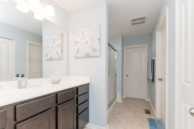 full bathroom with double vanity, a stall shower, a sink, and visible vents