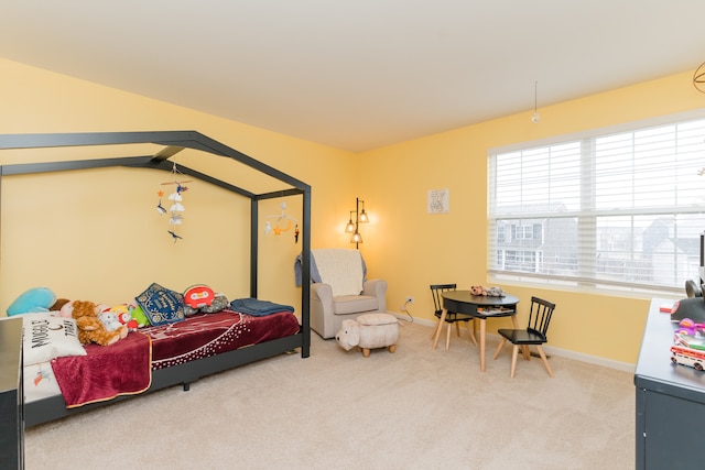 bedroom featuring carpet and baseboards