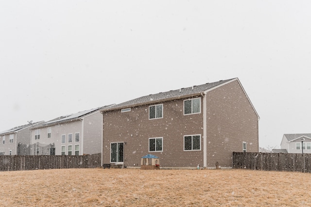 rear view of house with fence