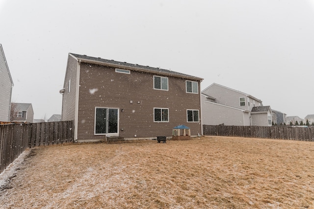 rear view of house with a fenced backyard