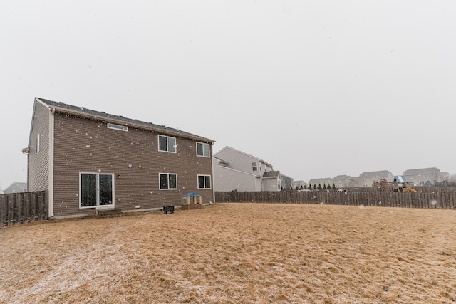 rear view of house with a fenced backyard