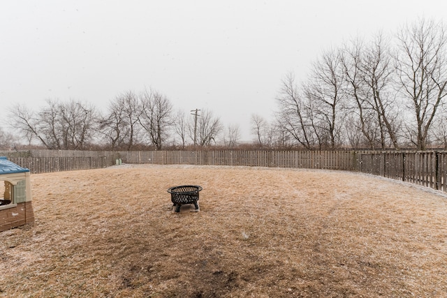 view of yard with an outdoor fire pit and a fenced backyard