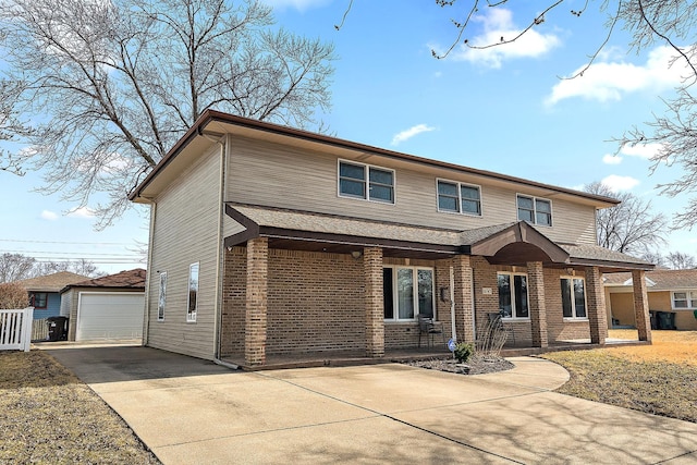 traditional home featuring driveway, a detached garage, covered porch, an outdoor structure, and brick siding