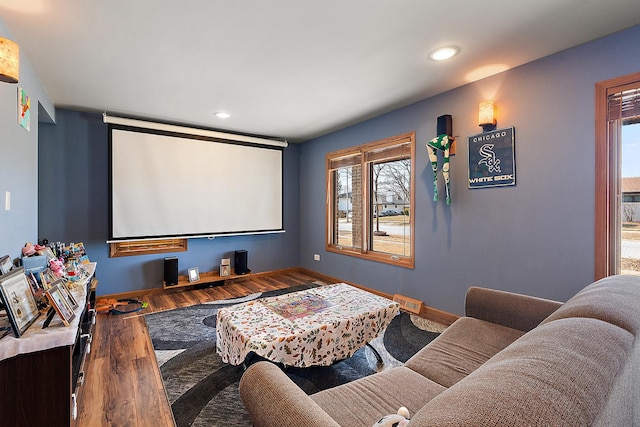 home theater room featuring recessed lighting, wood finished floors, and baseboards