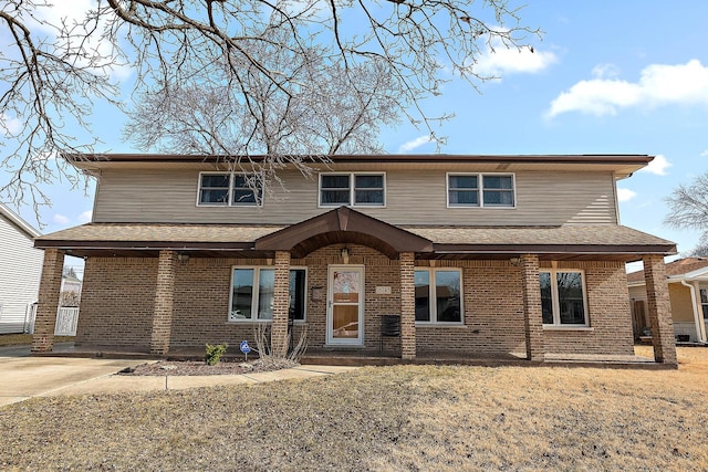 traditional home featuring brick siding