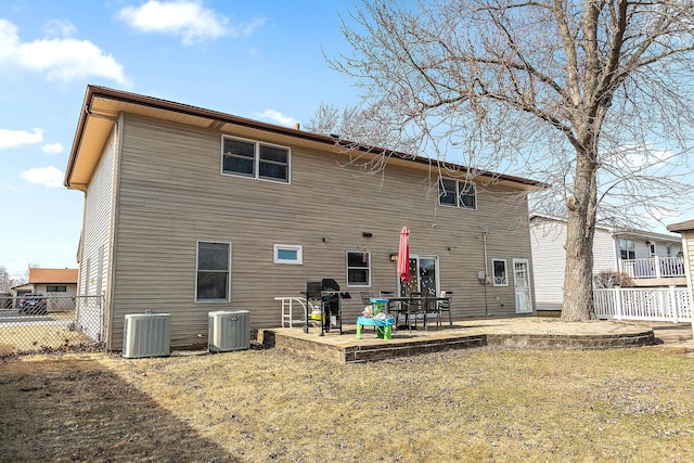 back of property with a patio, central air condition unit, and fence