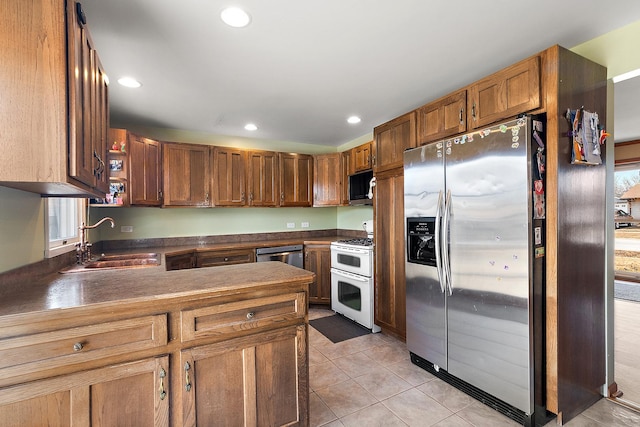 kitchen featuring light tile patterned floors, recessed lighting, a sink, stainless steel appliances, and dark countertops