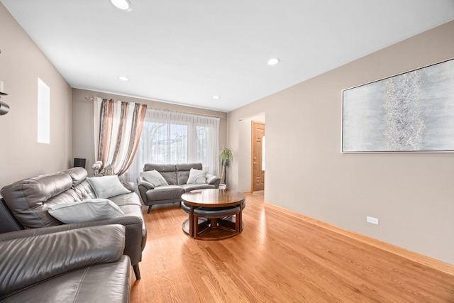 living area featuring light wood-style flooring and recessed lighting