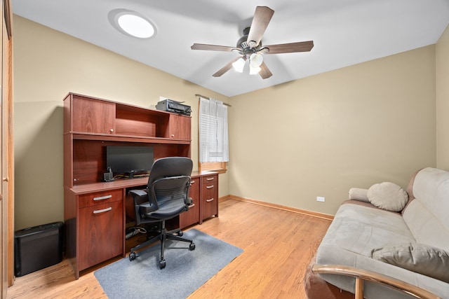 office with light wood-style floors, ceiling fan, and baseboards