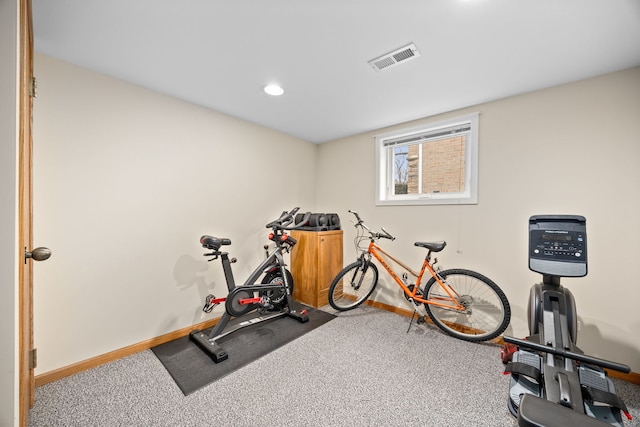 workout area with baseboards, visible vents, and carpet flooring