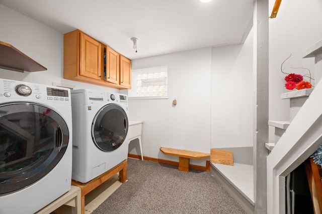 laundry area with light carpet, independent washer and dryer, cabinet space, and baseboards