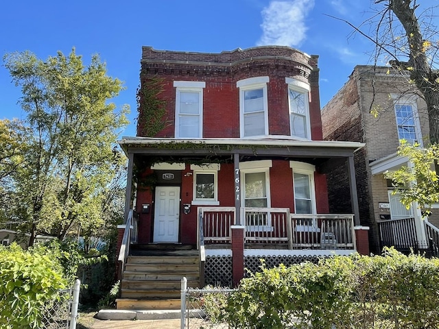 view of front of house featuring a porch and brick siding