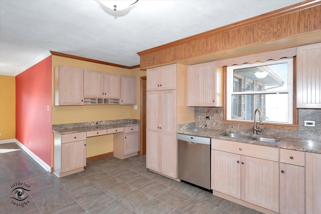 kitchen featuring a sink, baseboards, stainless steel dishwasher, and light brown cabinets