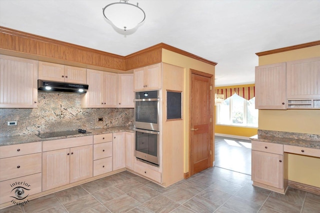 kitchen with light stone countertops, under cabinet range hood, light brown cabinetry, double oven, and black electric cooktop