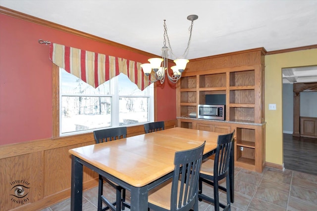 dining space with a chandelier and crown molding