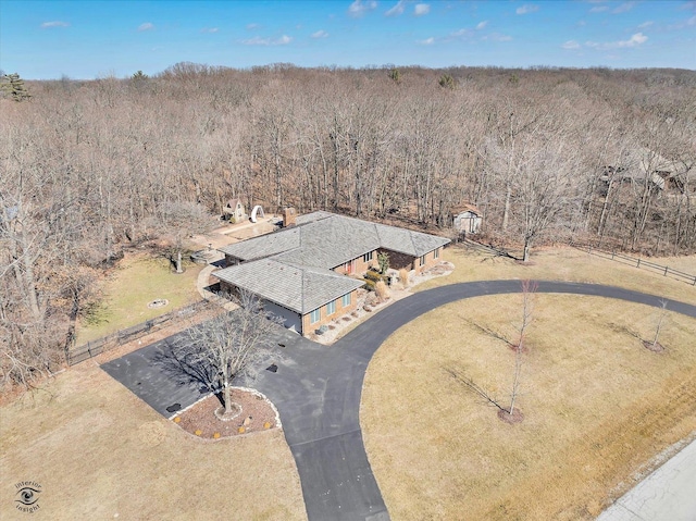 drone / aerial view featuring a view of trees