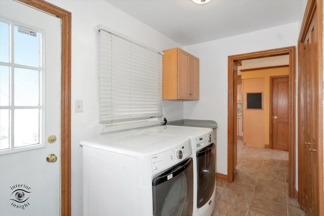 laundry area featuring cabinet space, light tile patterned floors, washer and dryer, and baseboards