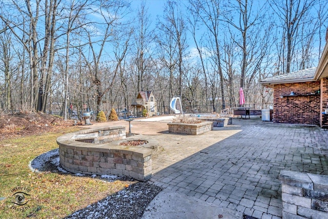 view of patio / terrace featuring an outdoor fire pit