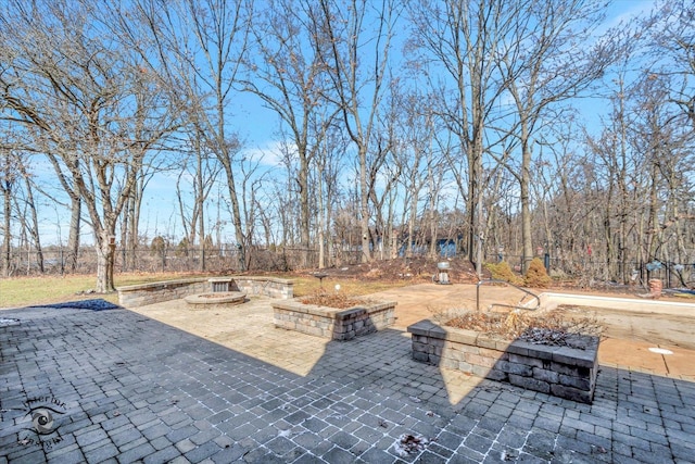 view of patio / terrace featuring fence and an outdoor fire pit