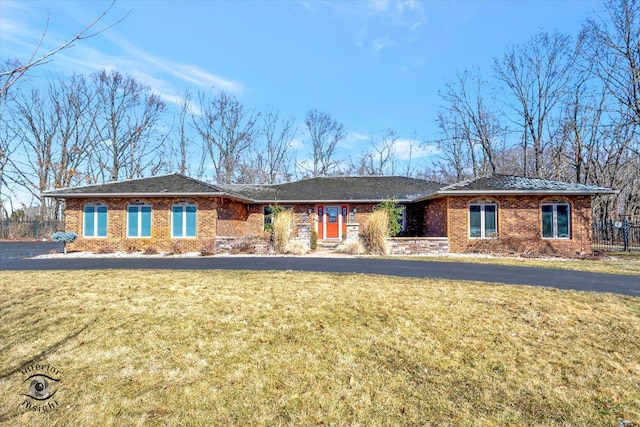 single story home with a front lawn and brick siding