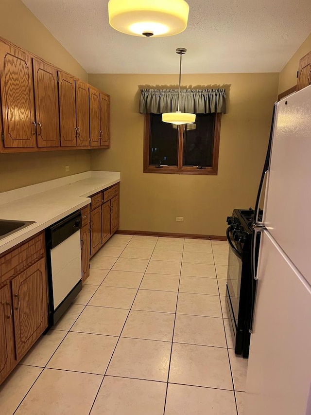 kitchen featuring brown cabinets, light tile patterned floors, light countertops, a textured ceiling, and white appliances