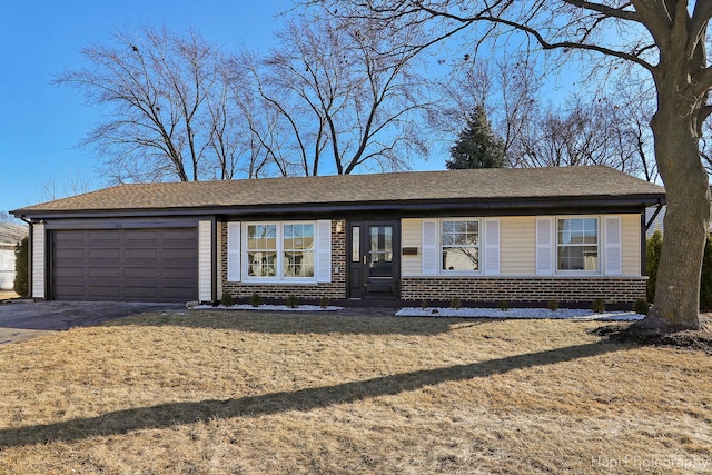 ranch-style house with entry steps, an attached garage, brick siding, and driveway